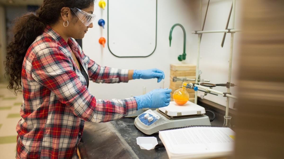 Christina weighing a beaker on a scale