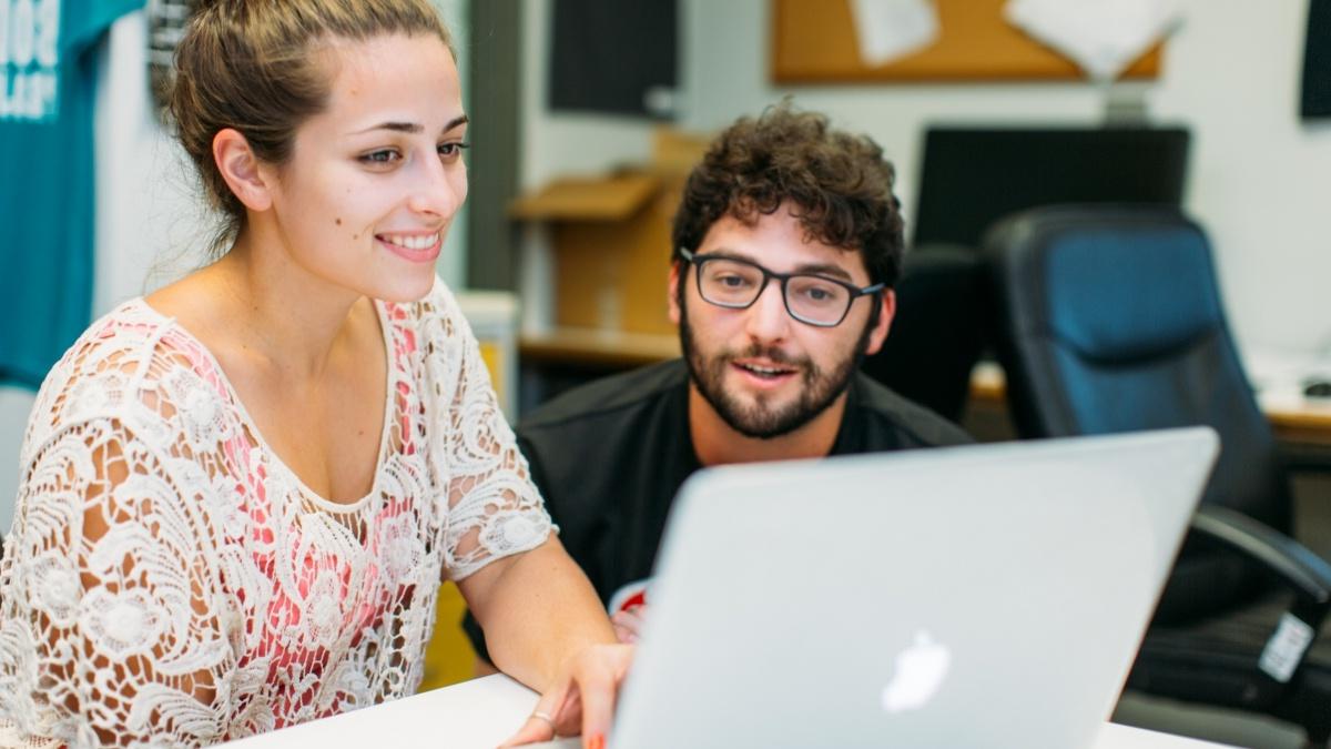 Two students looking at a computer screen